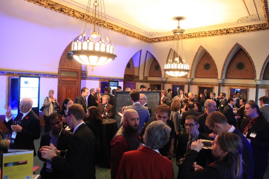 Perimeter's Hill day view inside a room full of people with government officials