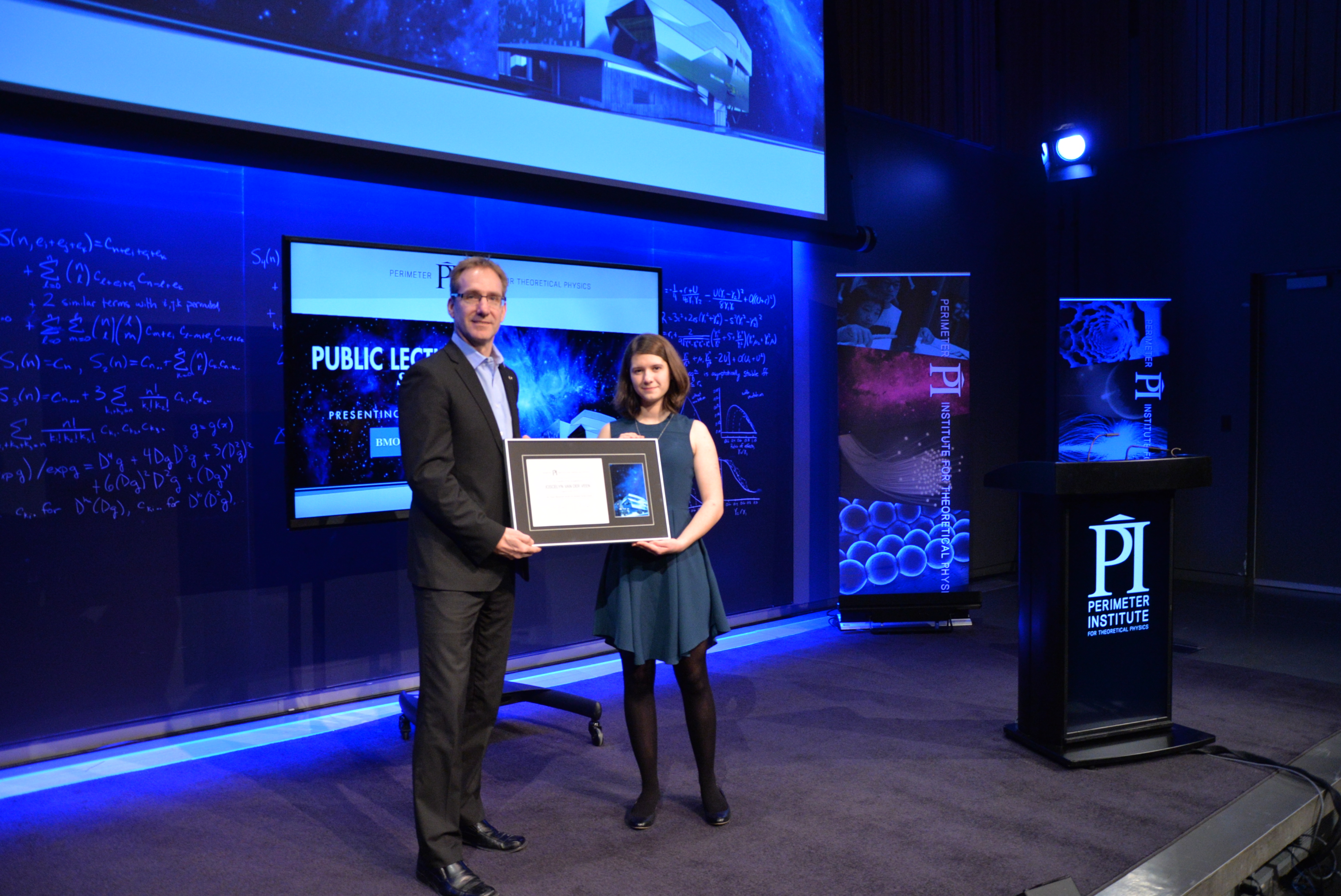 Joscelyn van der Veen receiving the Luke Santi Award from Director of Educational Outreach Greg Dick.