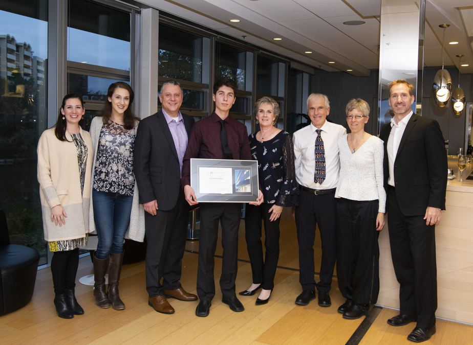 The Santi and Richards families celebrating with Aidan Richards  as he receives the Luke Santi Award. 