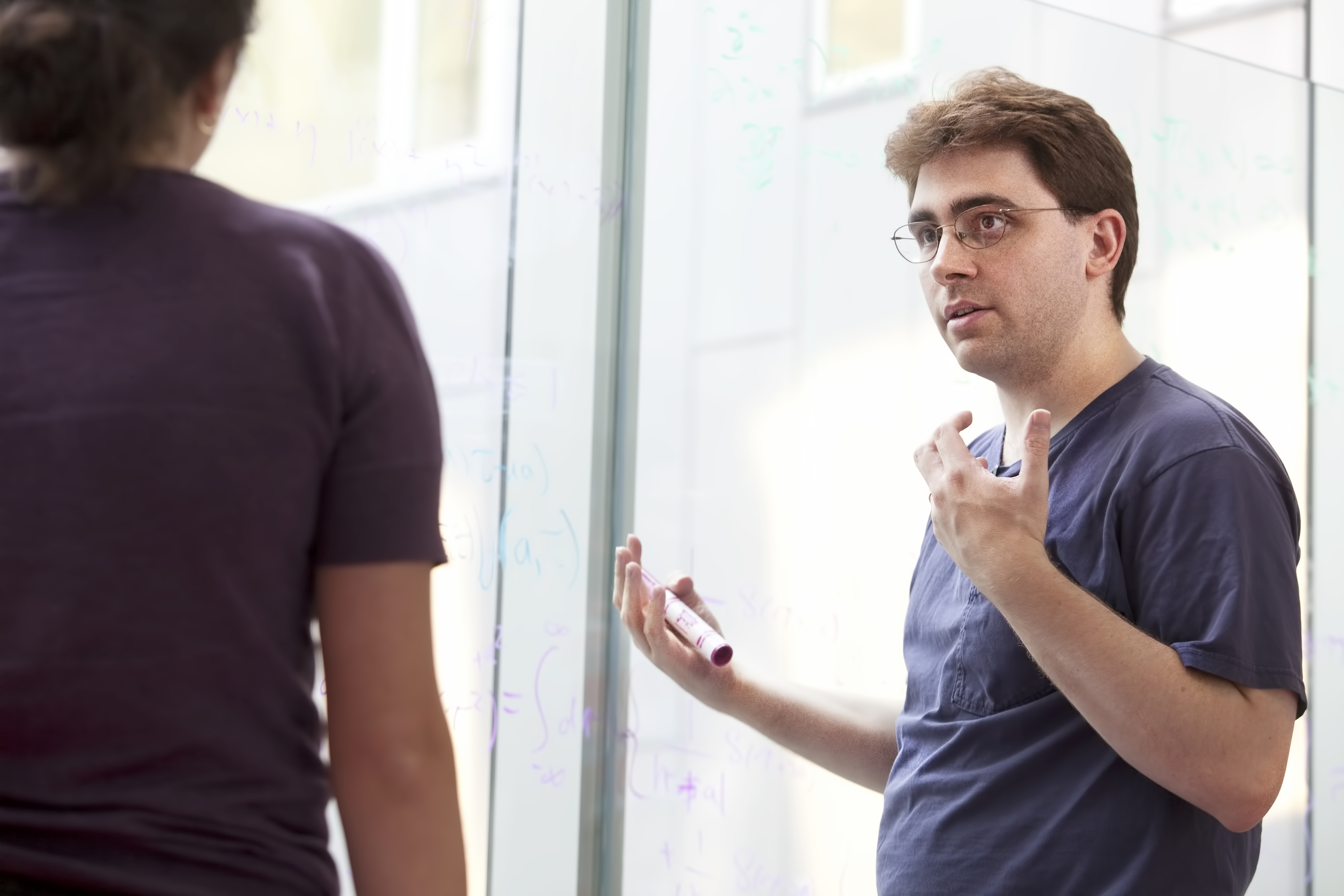 Perimeter Institute Faculty member Philip Schuster talking with Natalia Toro