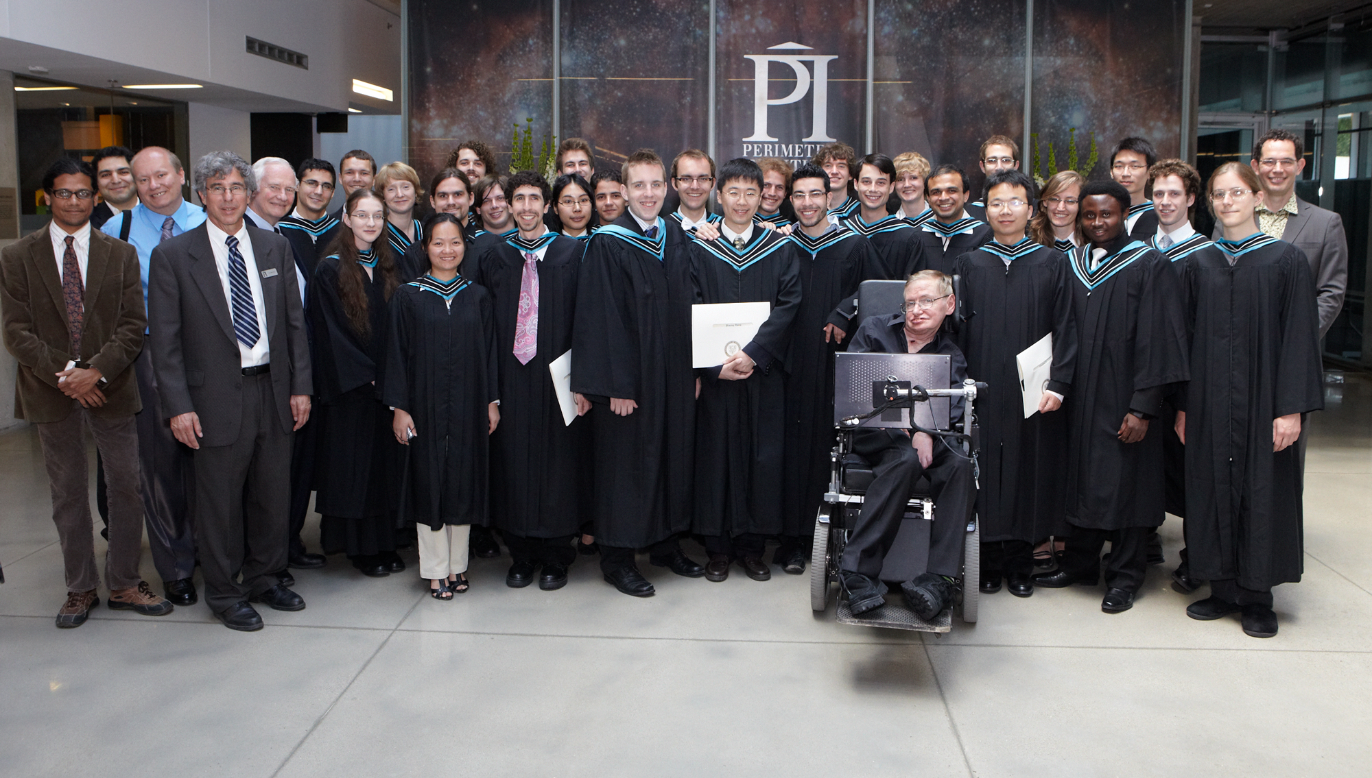 Group shot of physics students at graduation with Stephen Hawking