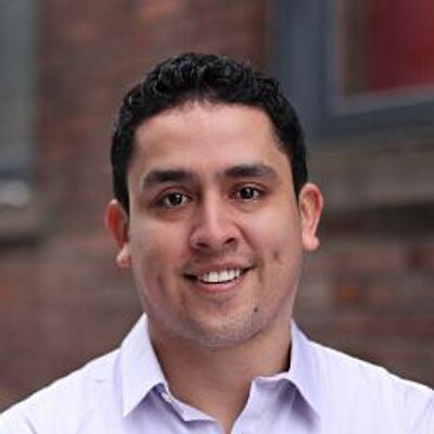 Jorge Escobedo standing in front of a brick wall