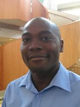 Portrait of a man standing in an atrium