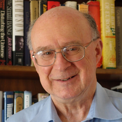 Portrait of an older man wearing glasses in a library