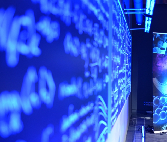 Close up angled shot of blackboard of equations with pop-up banner in background