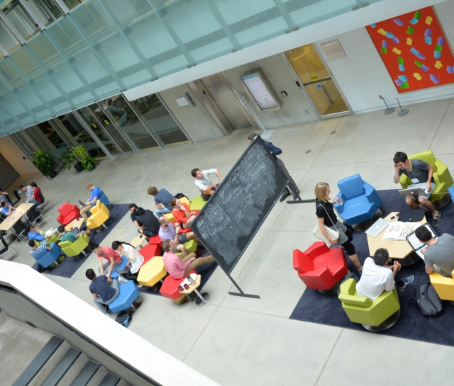 Aerial shot of groups of people interacting in an atrium