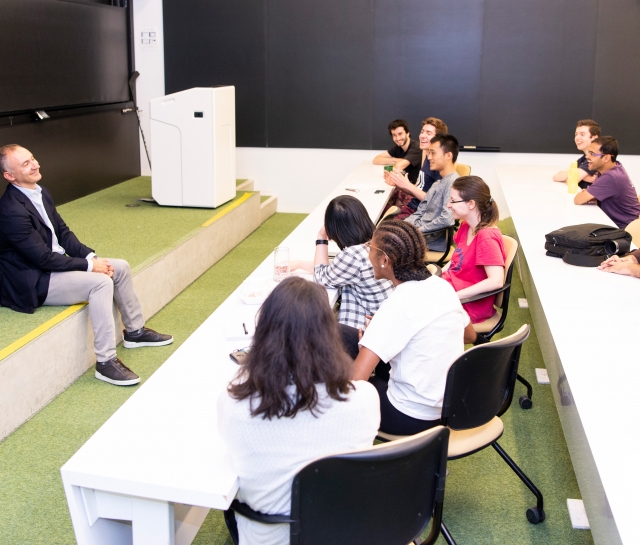 Man talking with a group of students