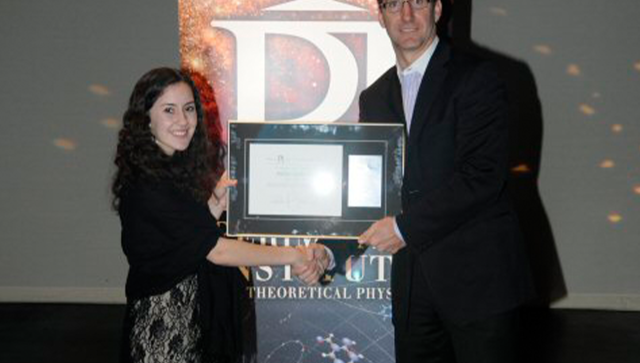 Paige Murphy, 2012 Luke Santi Memorial Award winner posing with her award and shaking the hand of Greg Dick, Perimeter Director of Educational Outreach,