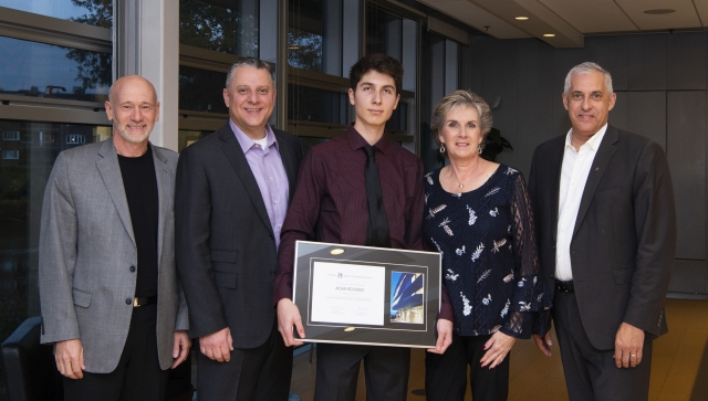 Group shot of young man and his family after receiving an award