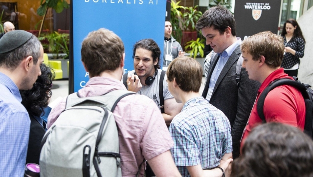 Group of men talking in an atrium