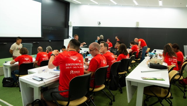 Group of teachers in a room doing a science workshop together