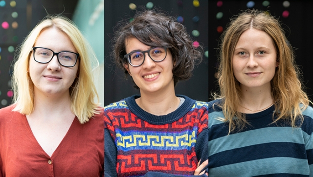 Portraits of three young women standing in an atrium