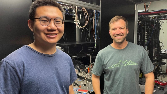 Two men standing in a computer lab together