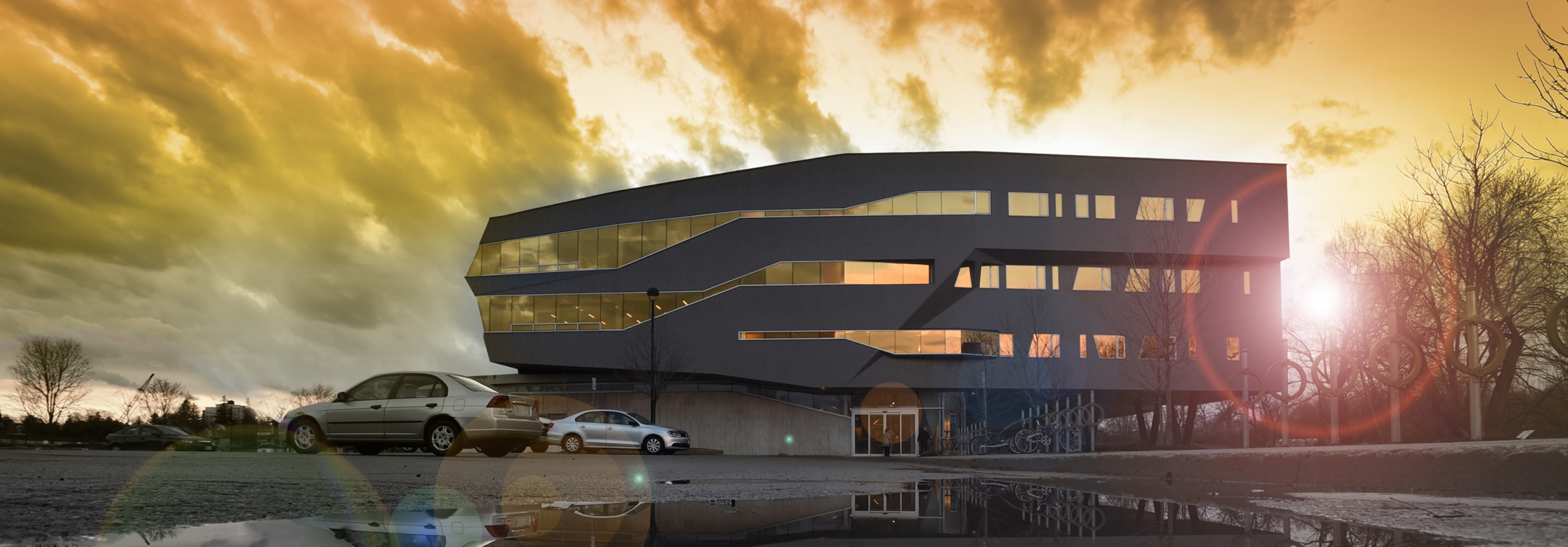 Perimeter Building facade yellow sky reflected in a puddle