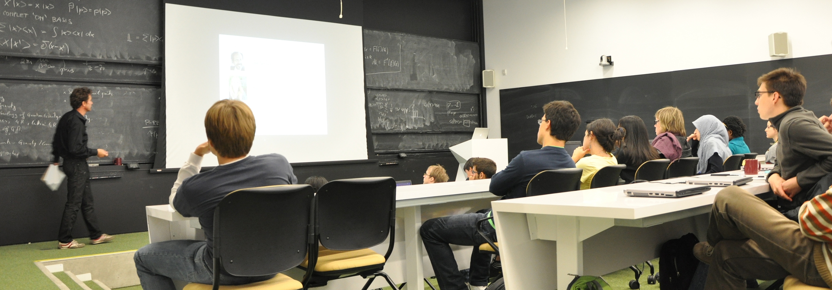 Students in a lecture hall listening to a seminar