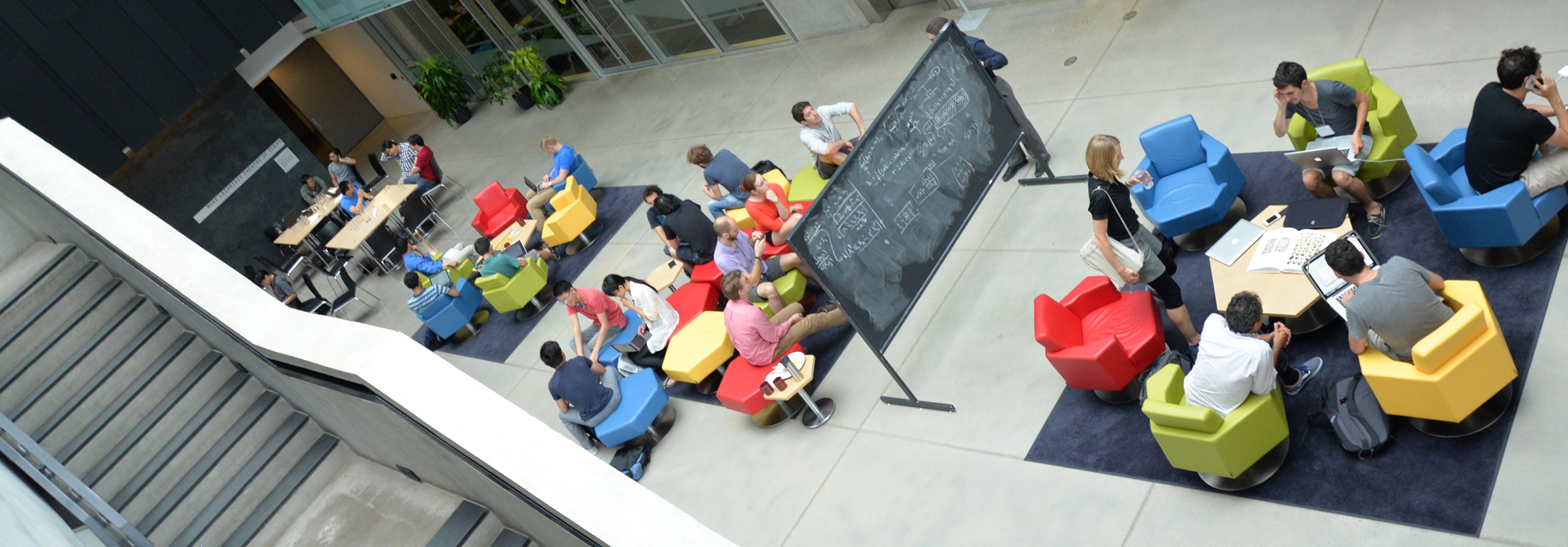 Groups of people interacting with each other in large atrium