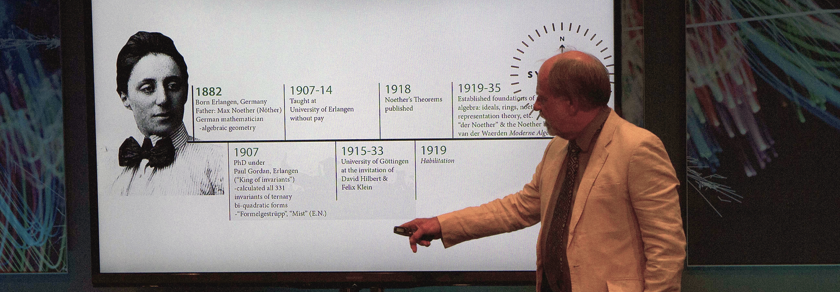 Man giving a presentation on Emmy Noether