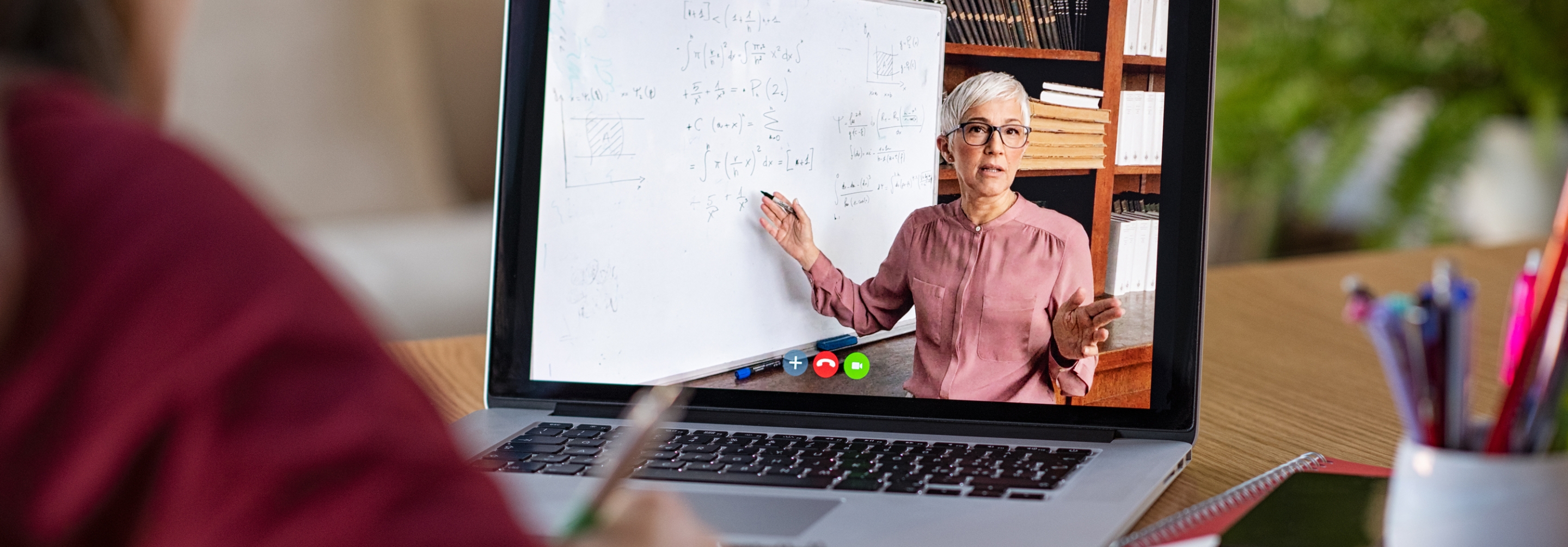 Woman doing a virtual class and teacher on computer screen teaching