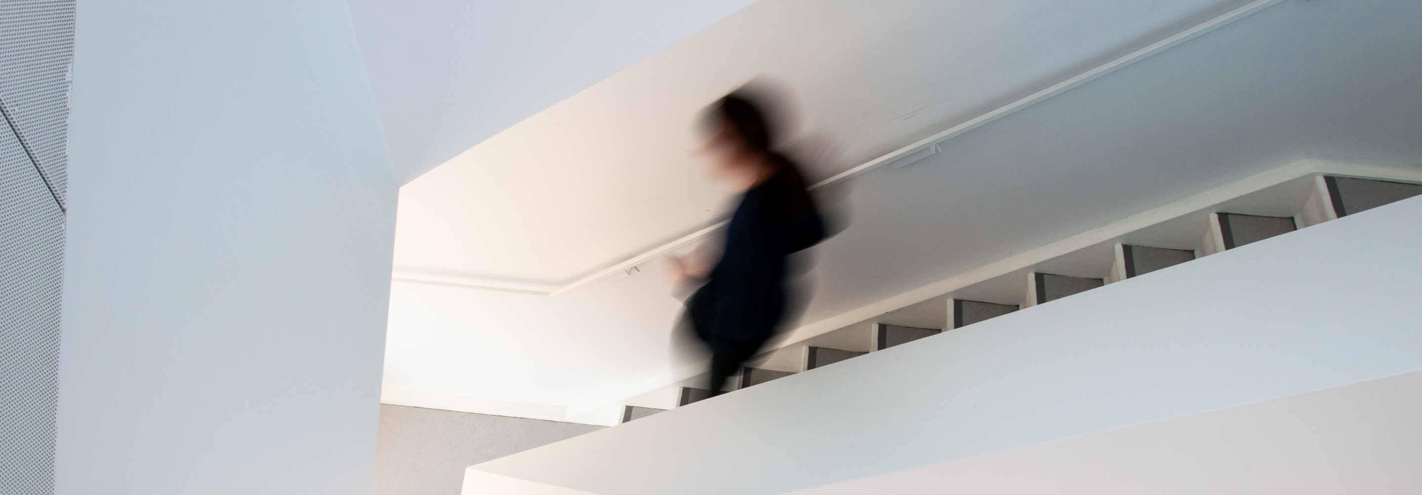 scientist walking down a staircase in the Perimeter building