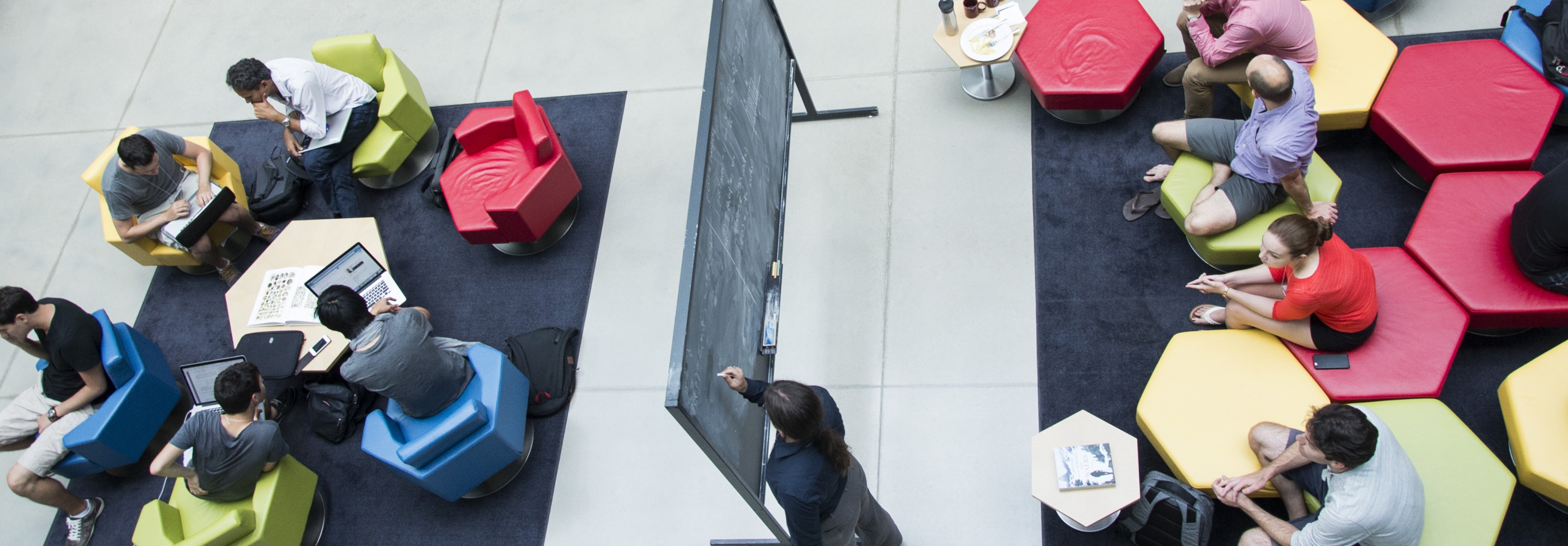 Aerial shot of groups of people interacting in an atrium