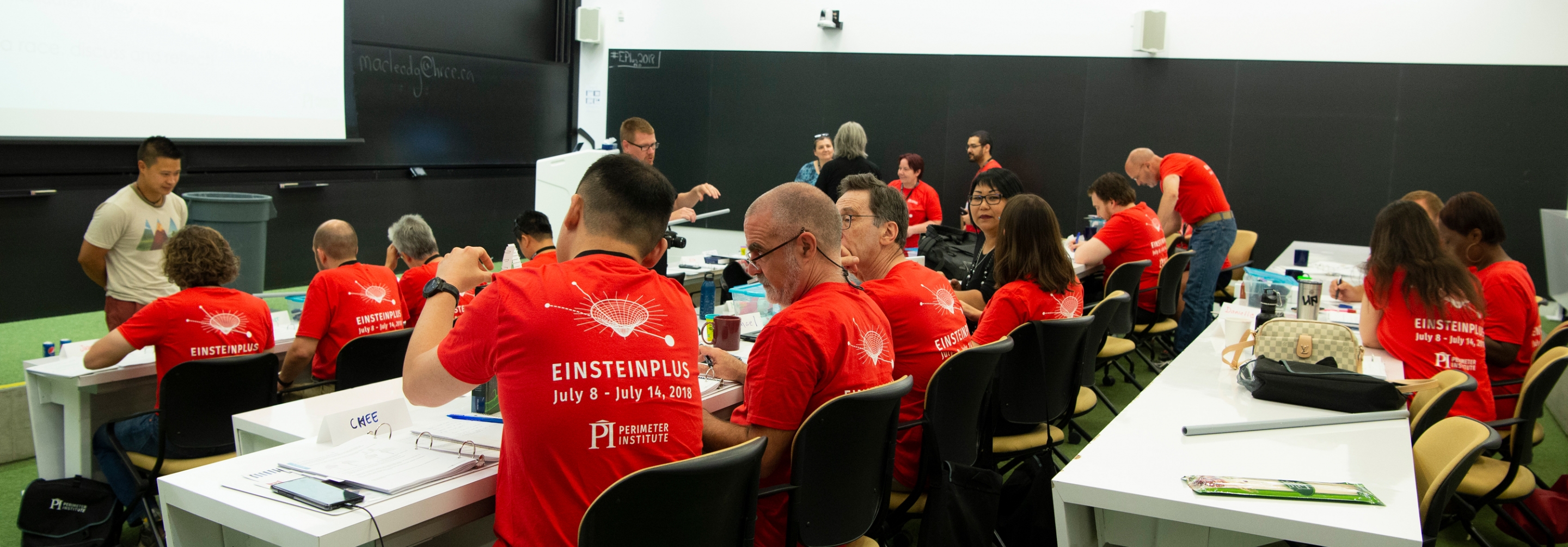 Group of teachers in a room doing a science workshop together