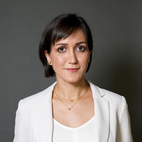 Portrait of a woman with short brown hair and cream suit