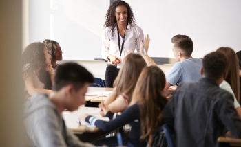 picture of a teacher in high school with a few students