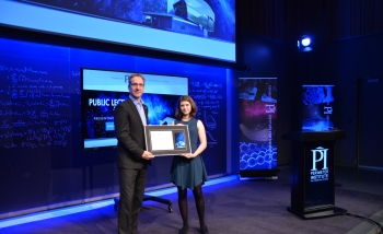 Joscelyn van der Veen receiving the Luke Santi Award from Director of Educational Outreach Greg Dick.