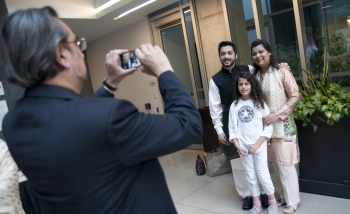 photo of a man photographing his family at PSI 2016 graduation 