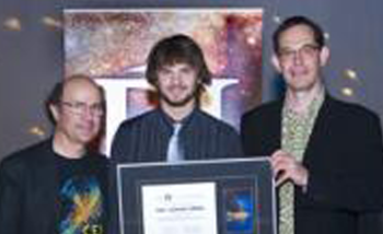 Luke Santi Memorial Award recipient Paul Brogee accepting the award from Nobel Laureate Frank Wilczek, and Director of PI Neil Turok.