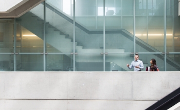 Perimeter Institute atrium stairway with two scientists interacting