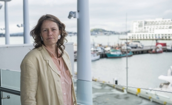 Woman infront of dock with boats