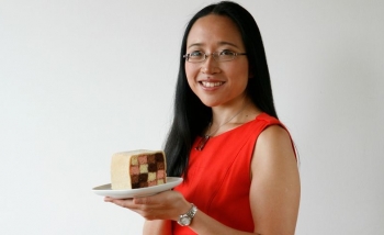 Woman smiling with cake in hand