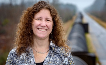 Portrait of woman smiling infront of pipe line