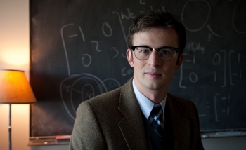 Portrait of man infront of chalkboard