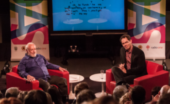 Two men talking on stage