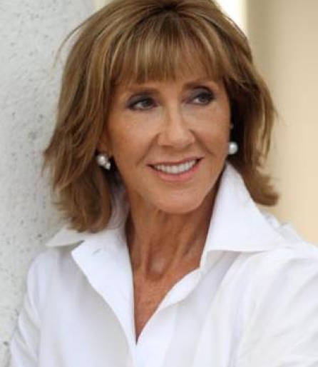 Portrait of a woman wearing a white shirt leaning against the door