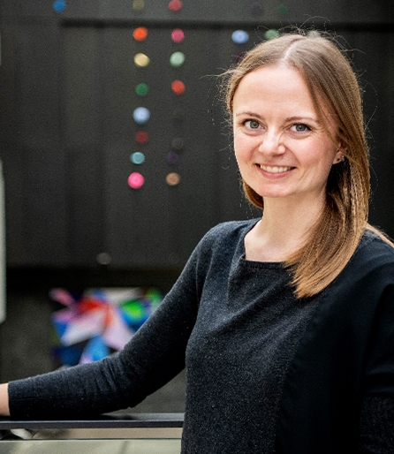 Photo of woman smiling in a large atrium